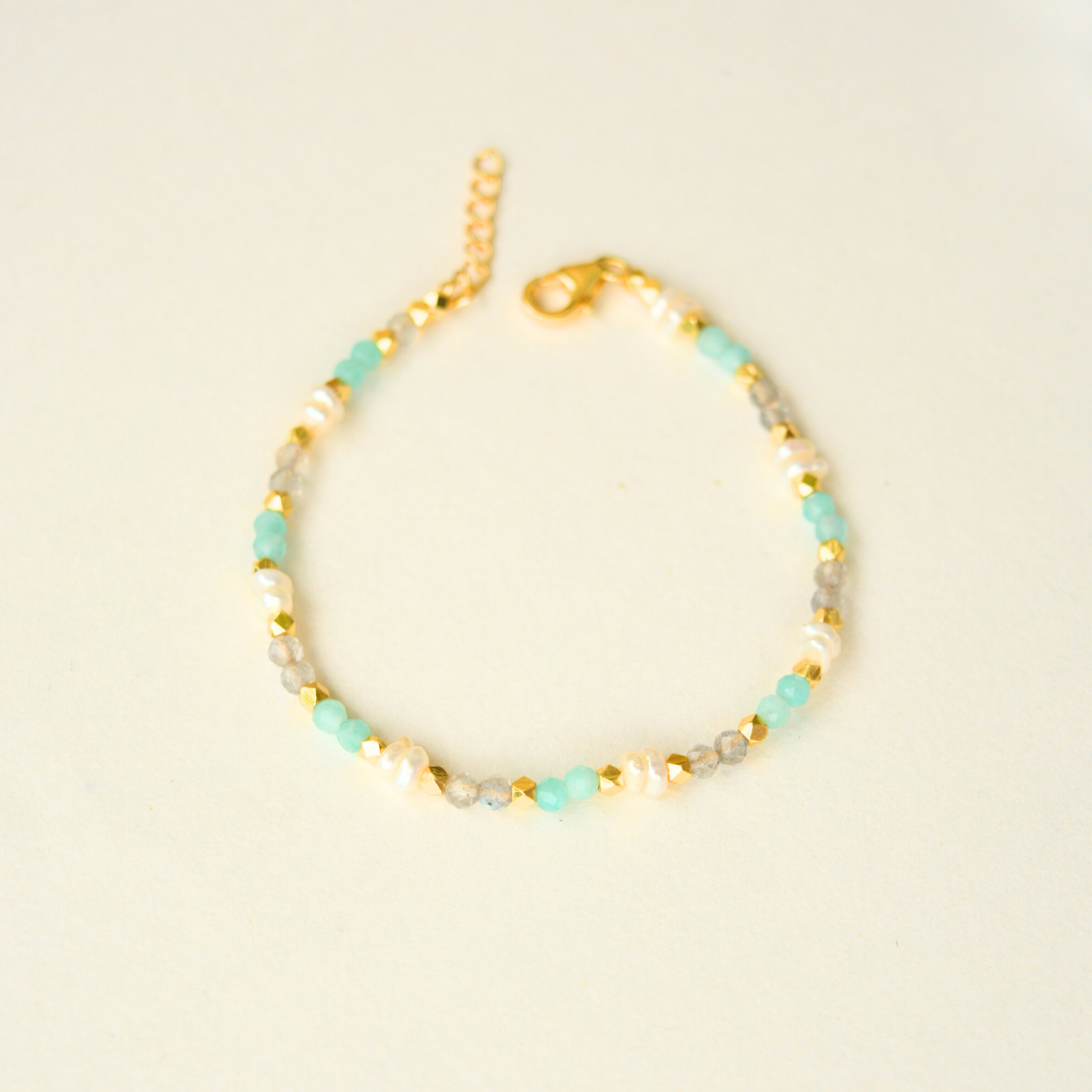 Adjustable beaded bracelet with faceted pastel gemstones and gold plating