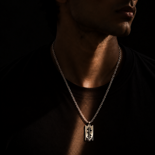 Man wearing the Mountains Are My Lifeline large 925 silver pendant on a silver chain with a black t-shirt