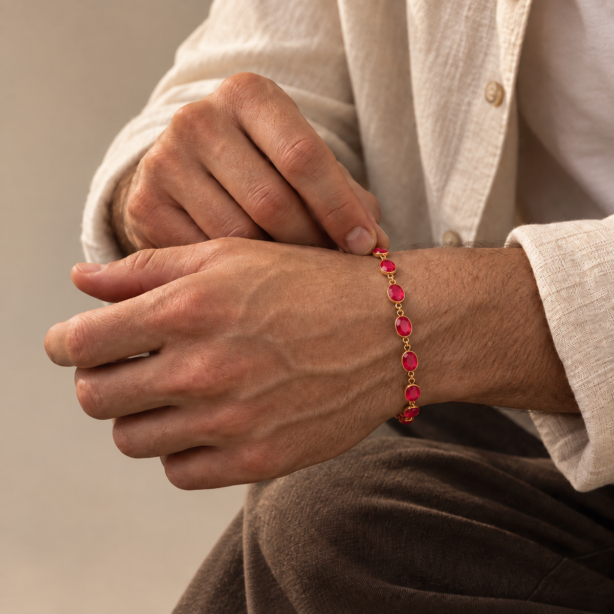 925 sterling silver bracelet with natural faceted pink jade gemstones in open bezel settings worn on a man's wrist