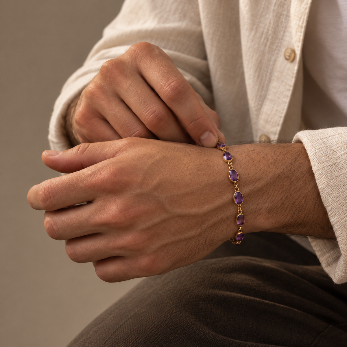 Amethyst Bracelet in 925 sterling silver with oval natural amethyst gemstones worn on a man's wrist.