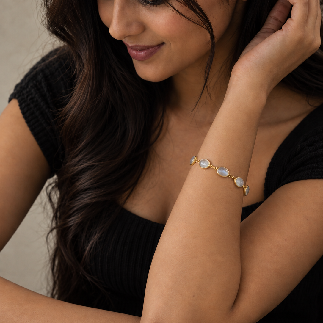 925 sterling silver Rainbow Moonstone Bracelet with faceted natural moonstone in open bezel settings worn on a woman's wrist.