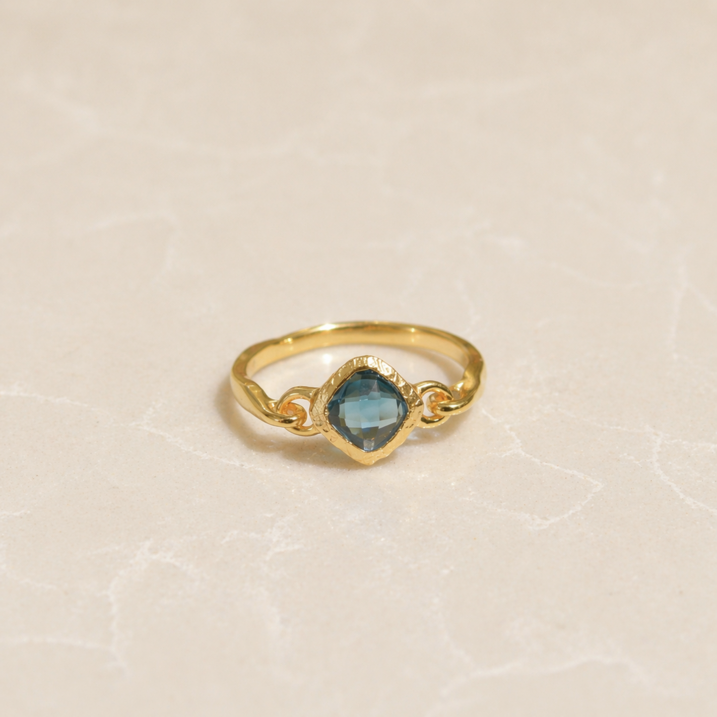 Front view of the Luminous Labradorite Ring featuring a square diamond-shaped stone with natural color flashes on a minimal neutral background.