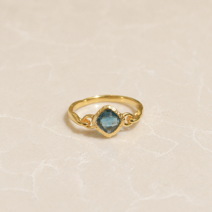 Front view of the Luminous Labradorite Ring featuring a square diamond-shaped stone with natural color flashes on a minimal neutral background.