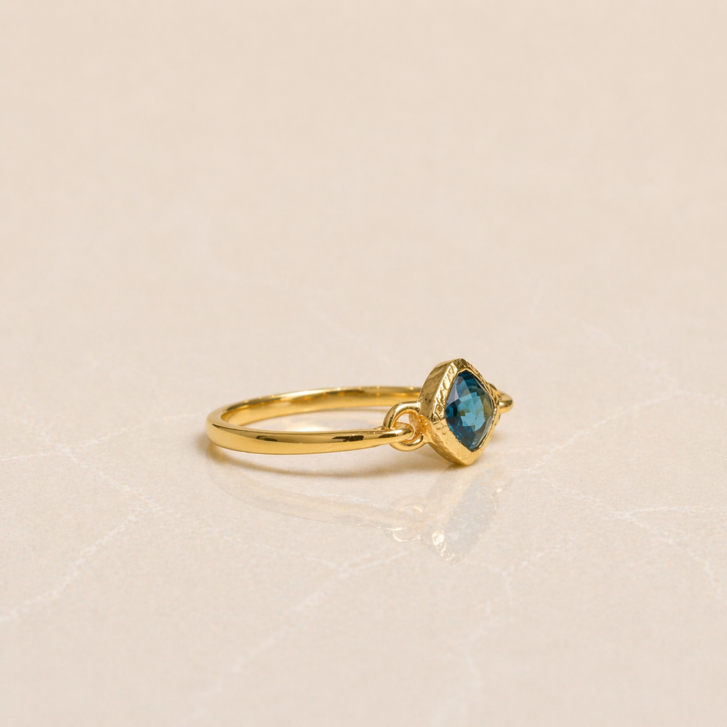 Side profile of the Luminous Labradorite Ring in 18kt gold-plated 925 sterling silver, showcasing the secure bezel setting and polished minimal band.