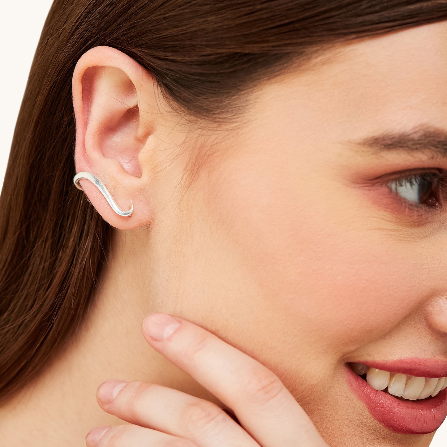 Portrait of a model wearing contemporary silver earrings, emphasizing their versatile and modern aesthetic for everyday wear.
