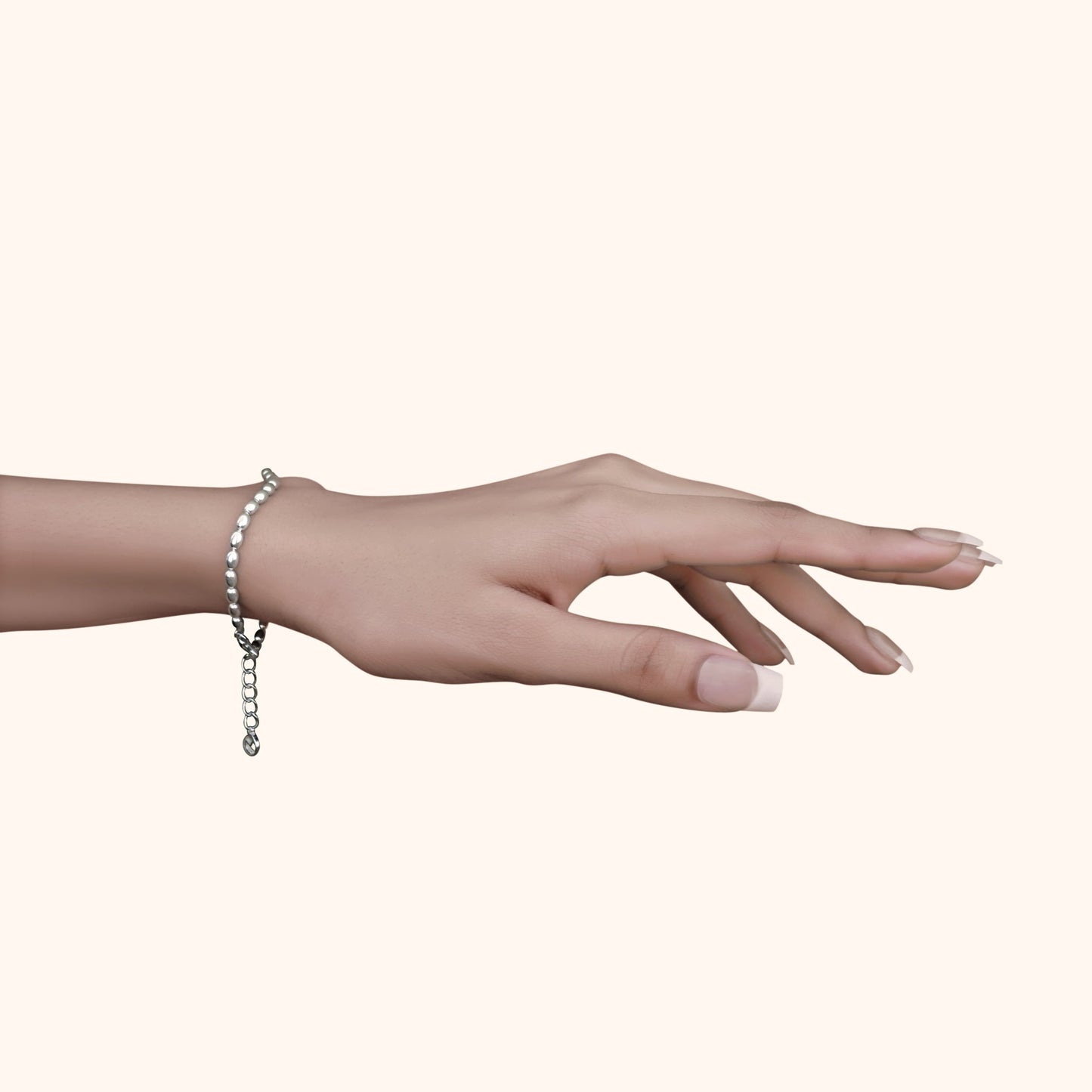 Graceful hand wearing a single fine silver bead bracelet with square accents, showcasing a minimalist and feminine jewelry style.