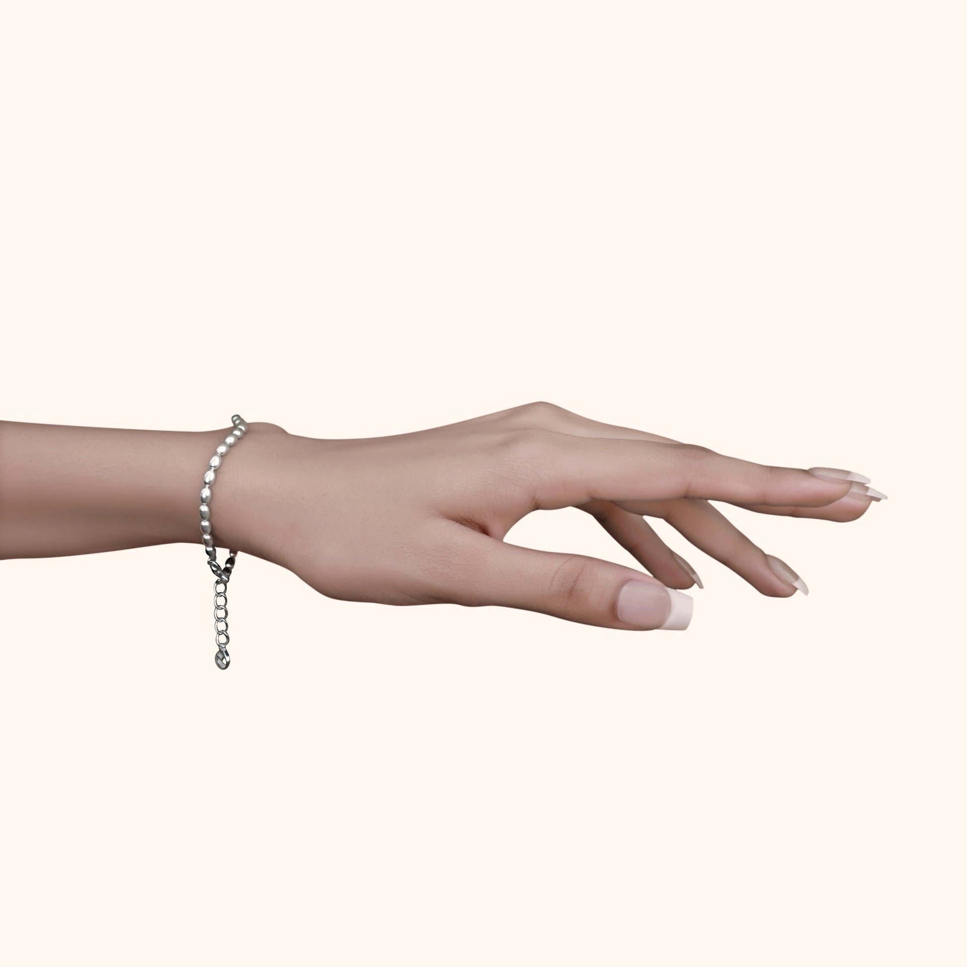 Graceful hand wearing a single fine silver bead bracelet with square accents, showcasing a minimalist and feminine jewelry style.
