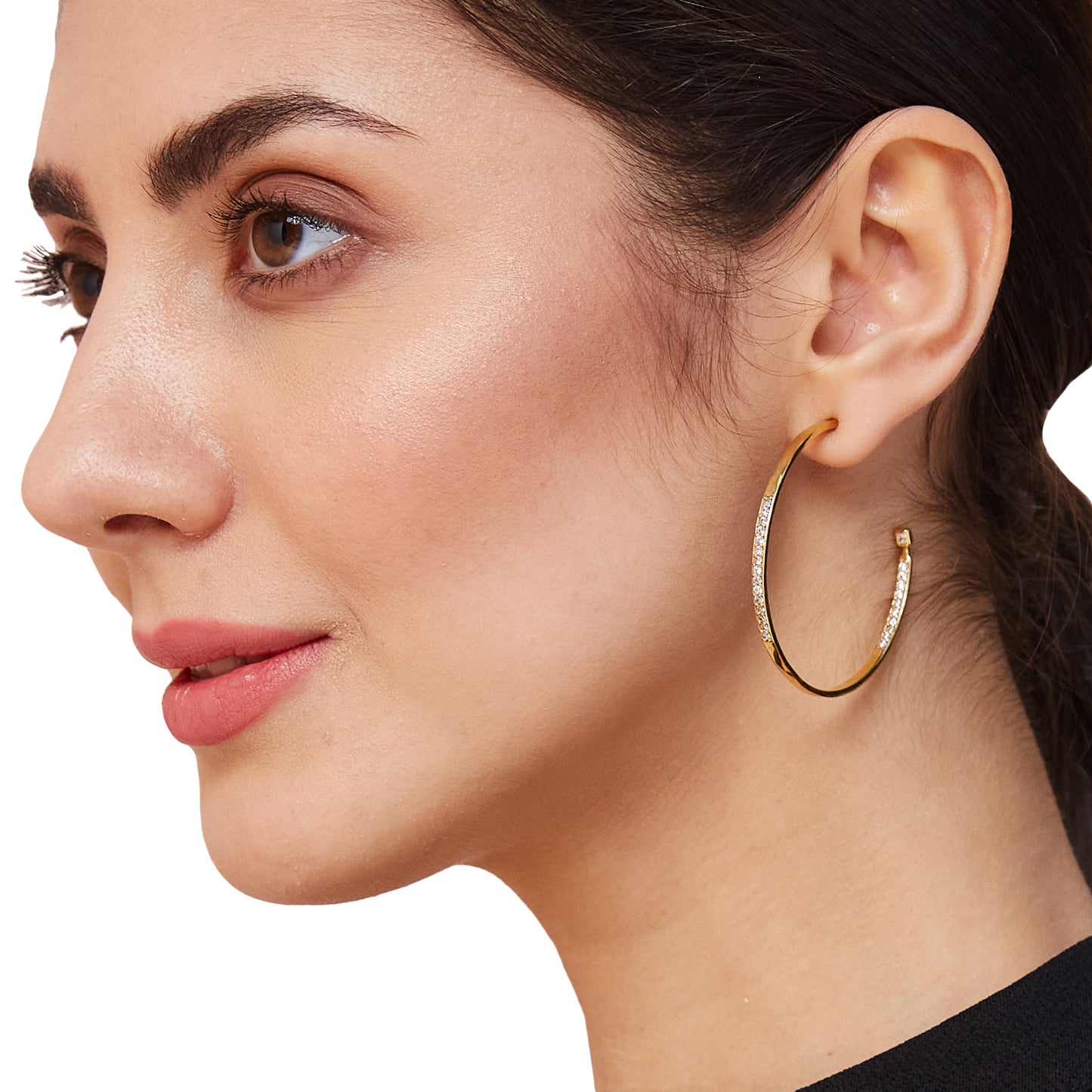 Portrait of a model showcasing wide-band gold hoops, worn as a versatile and minimalist accessory for a sophisticated look.