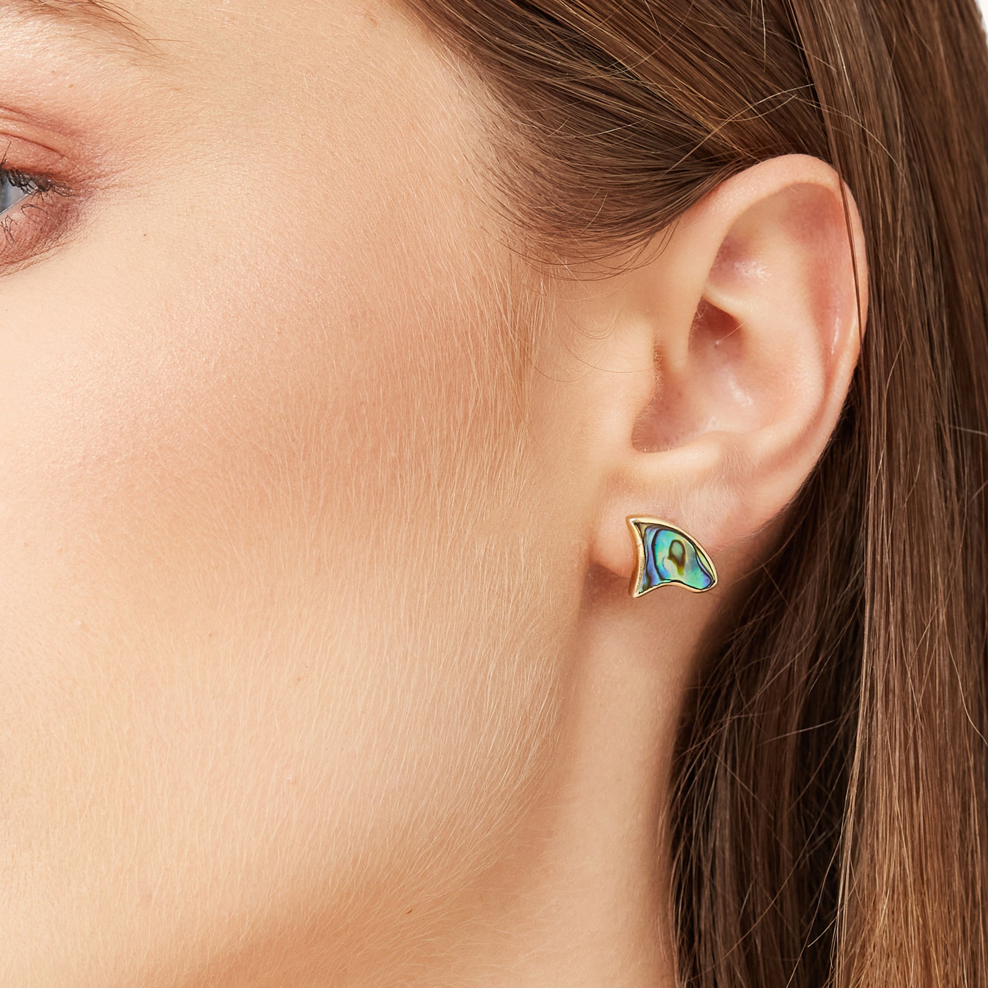 Detail shot of the abalone stud portion of the Ethereal Shoulder Duster worn alone on the ear for a minimalist look.