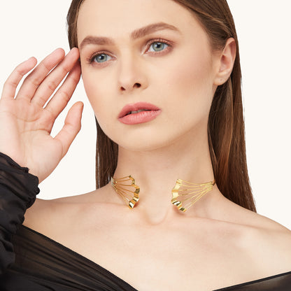 Editorial portrait of a model with slicked-back hair wearing the Gold Flow Necklet, styled with a black sheer outfit.