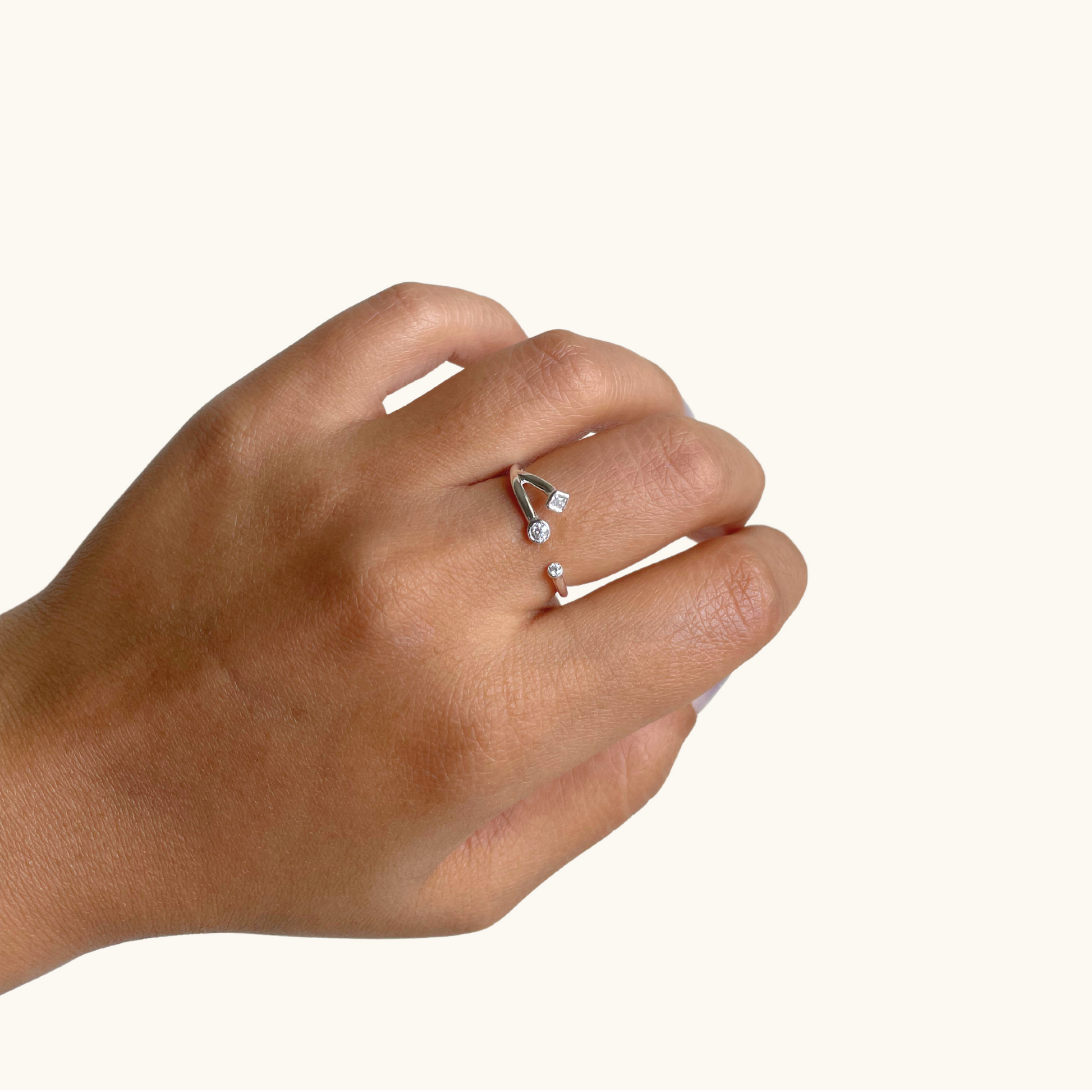 A hand wearing an elegant, dainty band adorned with shimmering star-shaped embellishments, styled for a refined and sophisticated everyday look.