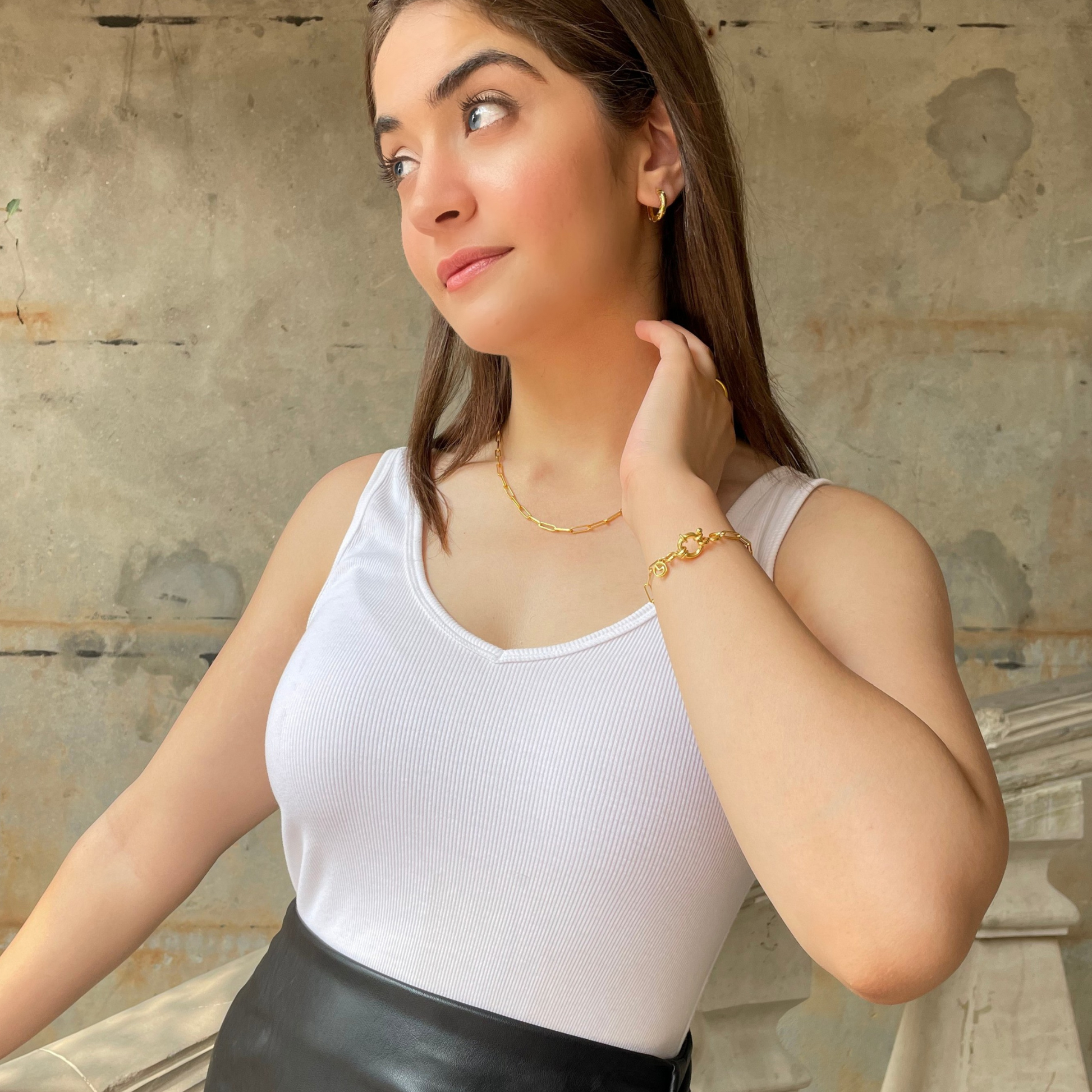 Close-up portrait of a model wearing a graceful, sterling silver necklace, highlighting its clean lines and timeless appeal.