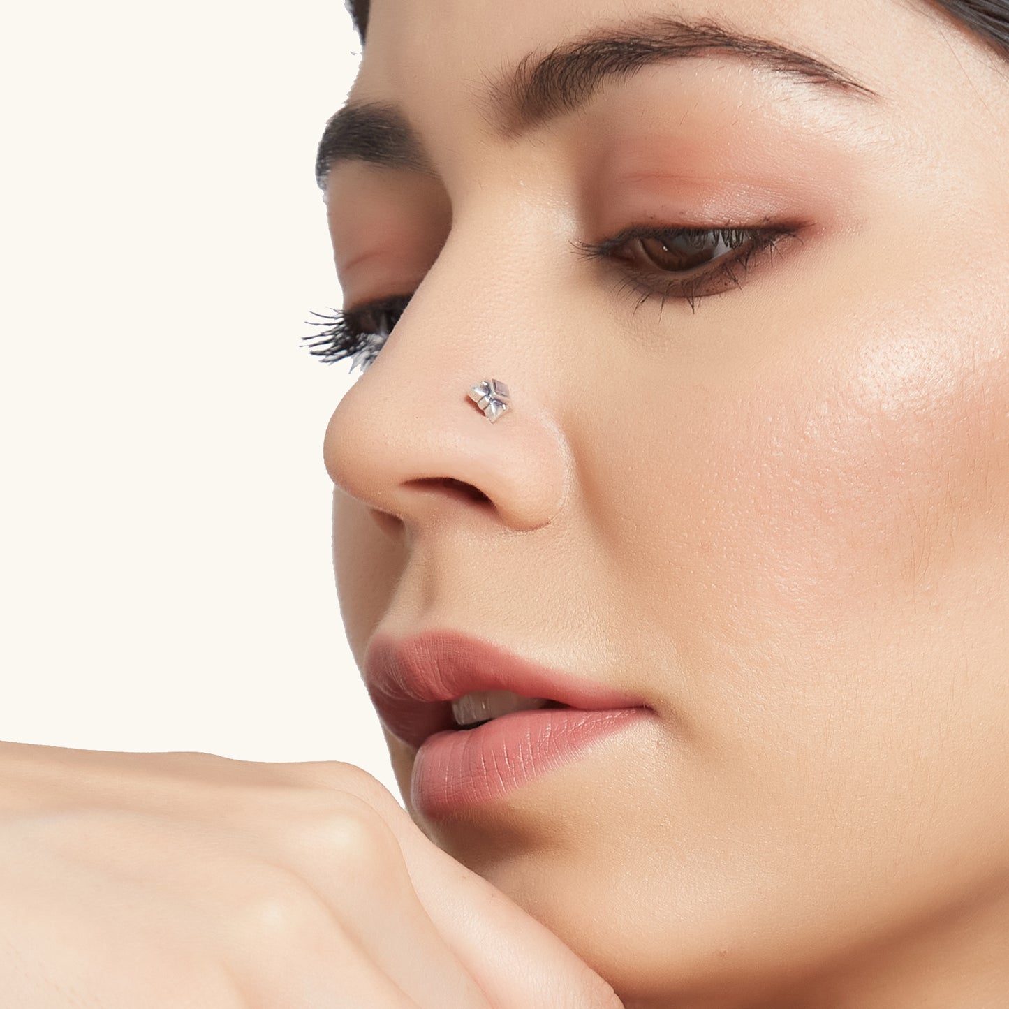 Side profile of a model wearing a silver nose accessory featuring a light purple gemstone at its center.