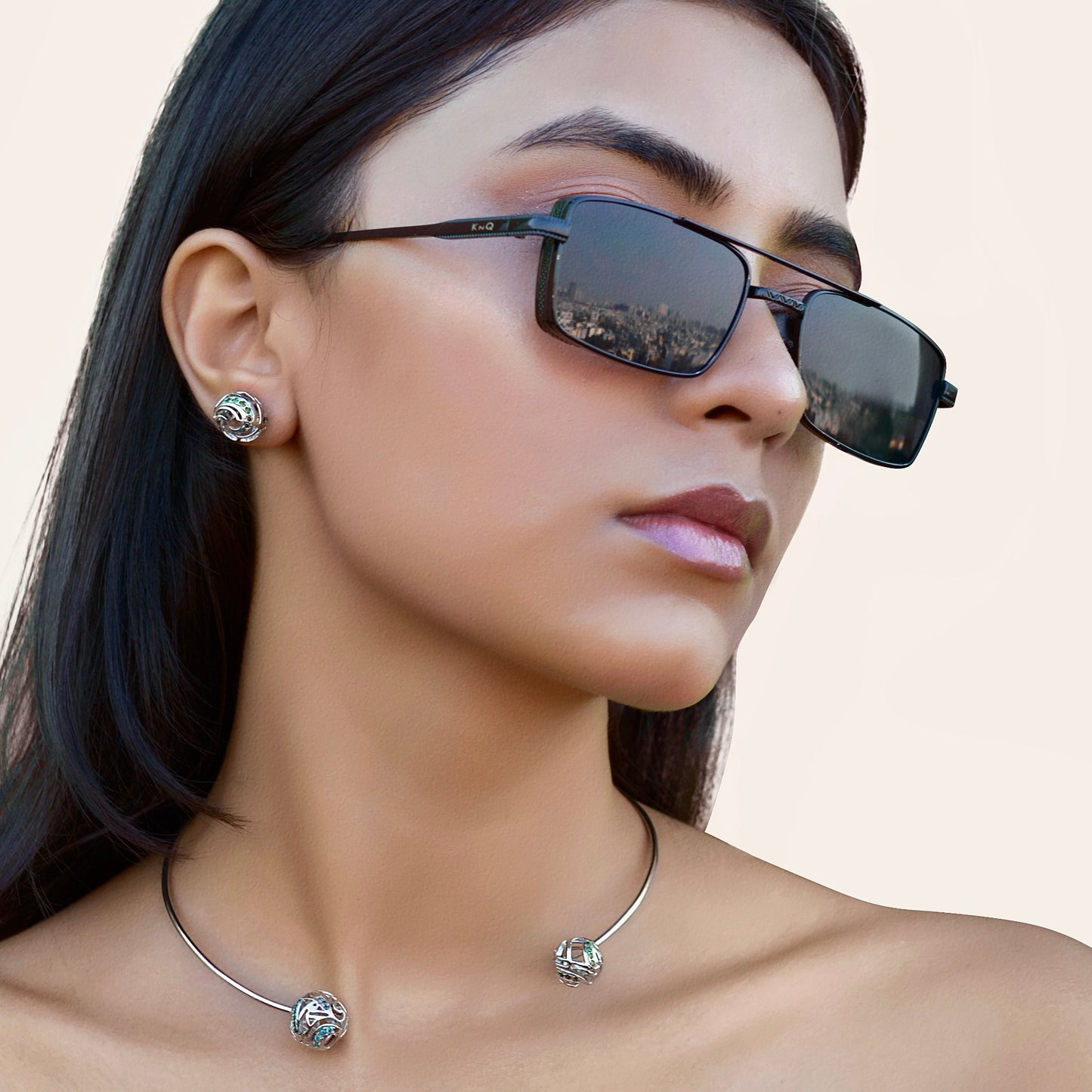 A close-up view of a person wearing a statement brass choker that sits comfortably at the base of the neck, highlighting its high-luster finish.