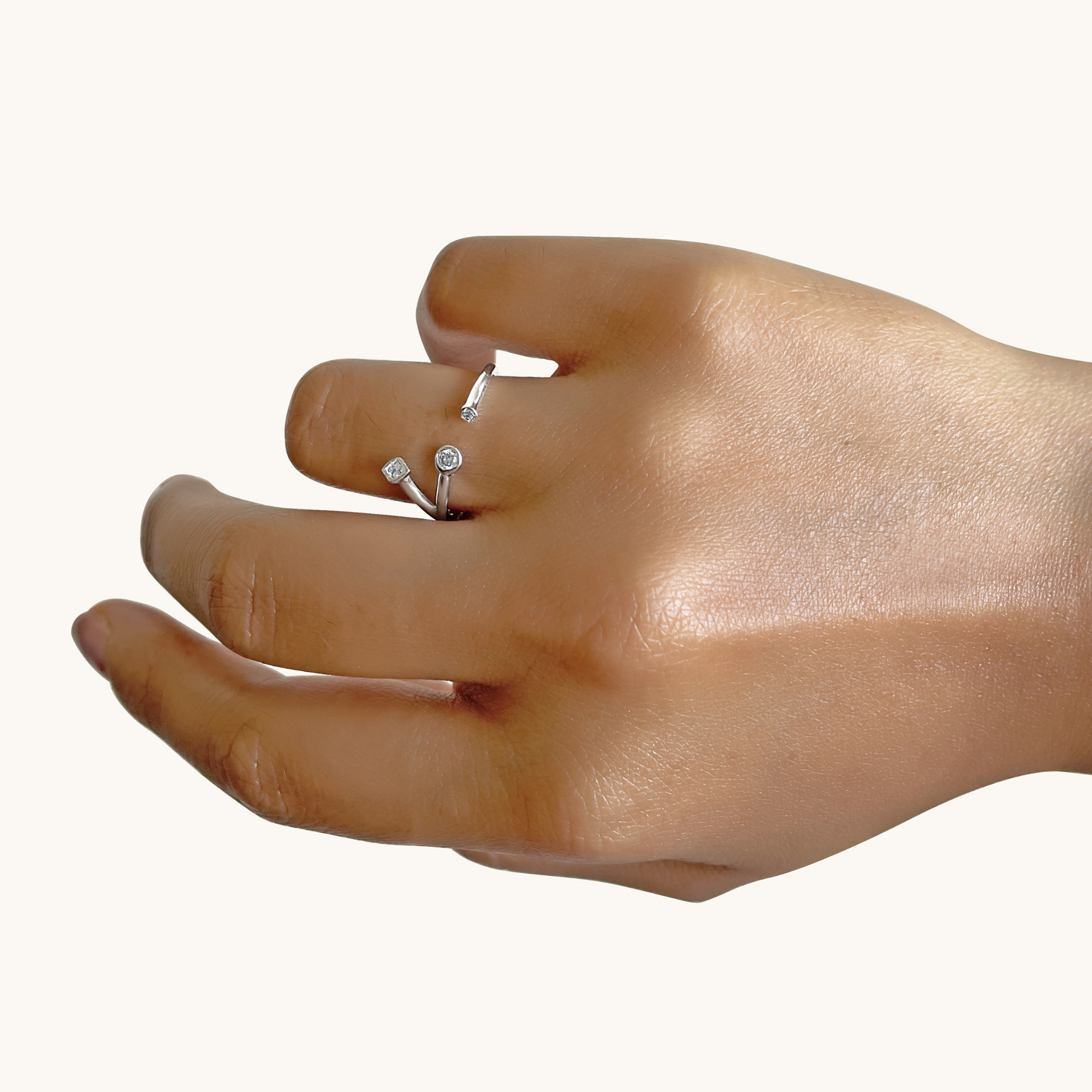 An angled view of a person wearing a celestial-themed ring, highlighting the intricate, sparkling star details and its comfortable, stackable design.