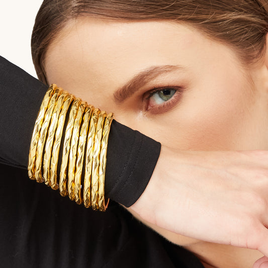 Portrait of a woman wearing a modern, mixed-metal infinity-style Bangles.