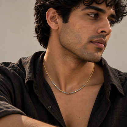 Calming Bead Necklace with multi-shade granite beads and gold accents styled on a male model.