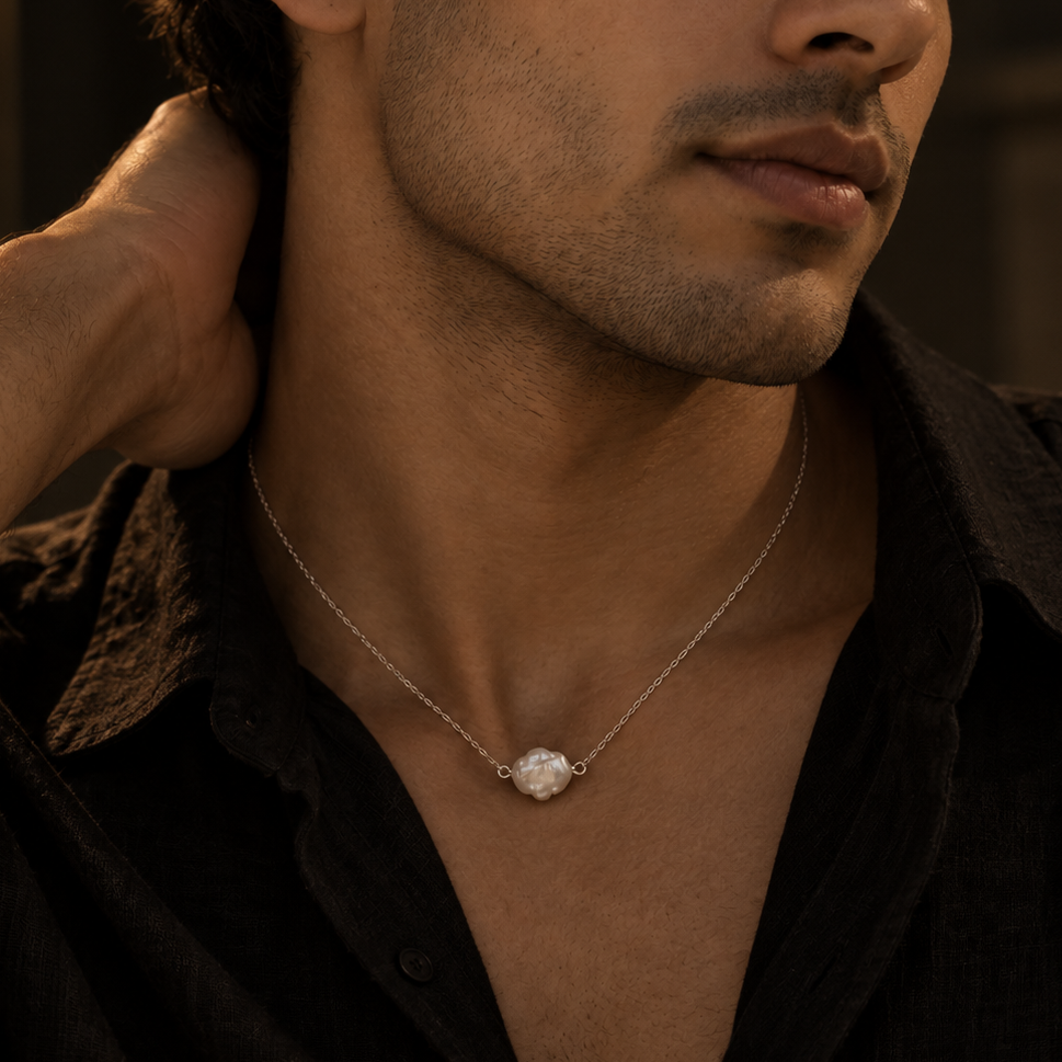Baroque Pearl Necklace with a unique natural pearl on a sterling silver chain, styled on a male model.