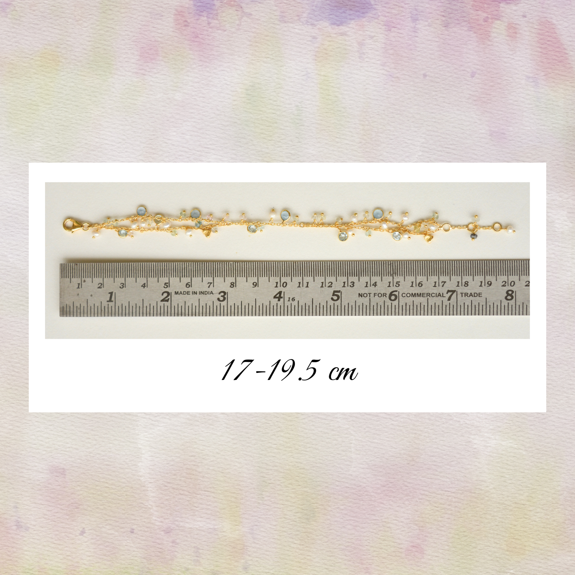 A macro detail shot highlighting the texture of the gold-plated silver chain and the unique shapes of the assorted gemstone, pearl charms and measurements.