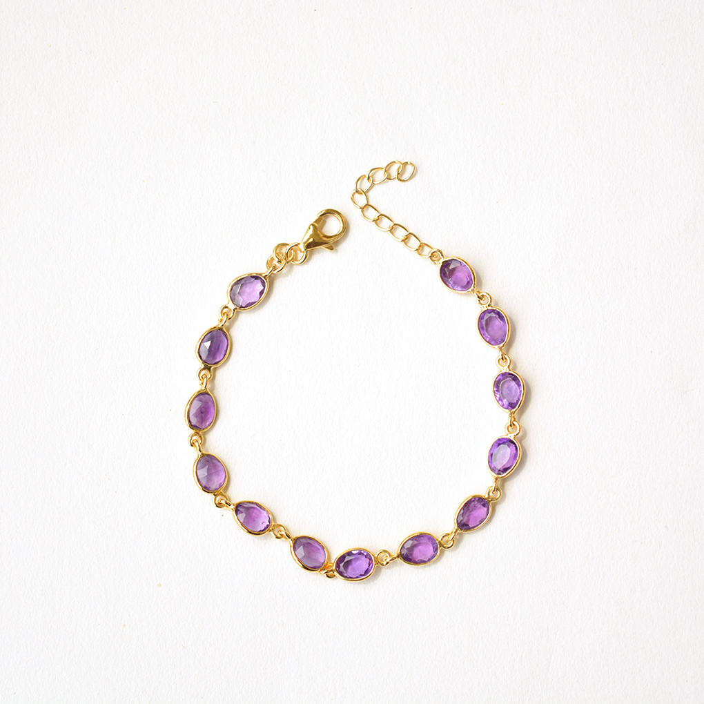 Dainty sterling silver chain bracelet featuring a deep purple, faceted stone charm.
