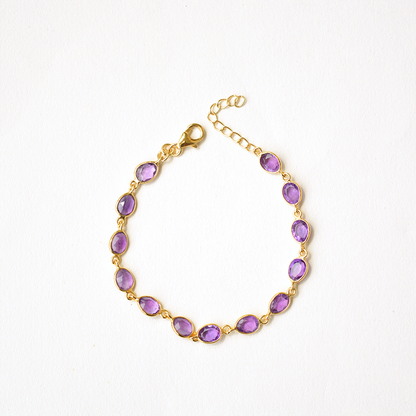 Dainty sterling silver chain bracelet featuring a deep purple, faceted stone charm.