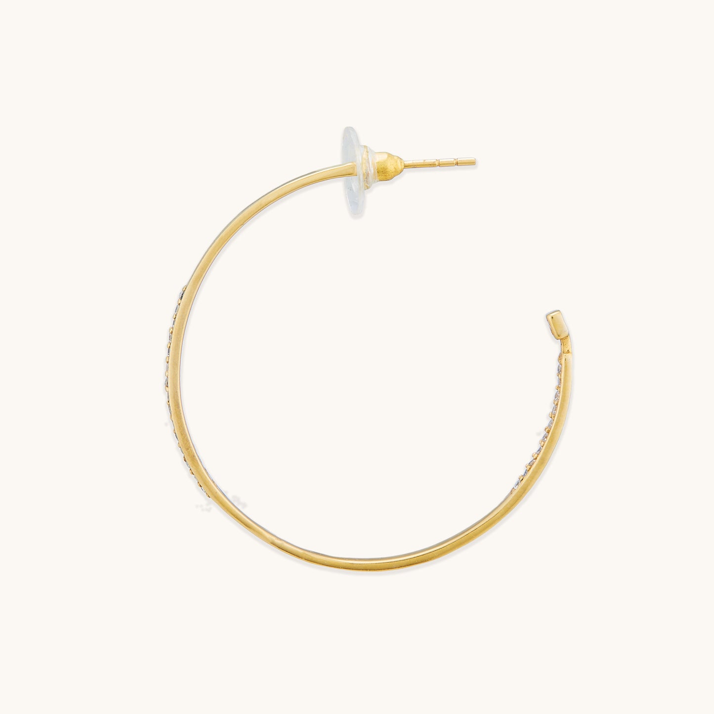 A pair of sculptural gold-plated hoops isolated on a white background, highlighting their refined, contemporary, and bold appearance.