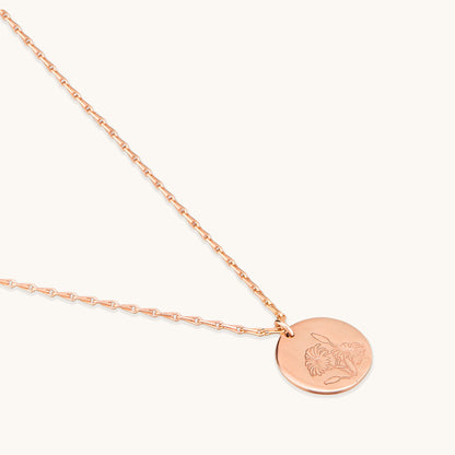 Close-up detail of the Daisy Medallion Necklace showing the intricate botanical engraving on the rose gold disc and the high-quality chain links.