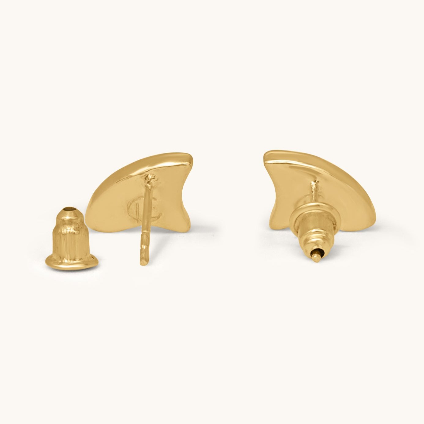 Rear view of gold wave earrings showing the metal posts and  back closures.