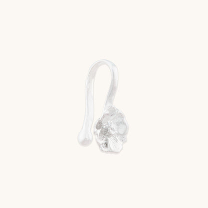 Side profile view of an elegant sterling silver nose jewelry piece, showing the secure clip-on hook mechanism and intricate flower design.