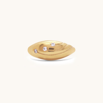 Front view of a gold dome ring showcasing its smooth, rounded design and three flush-set gemstones.
