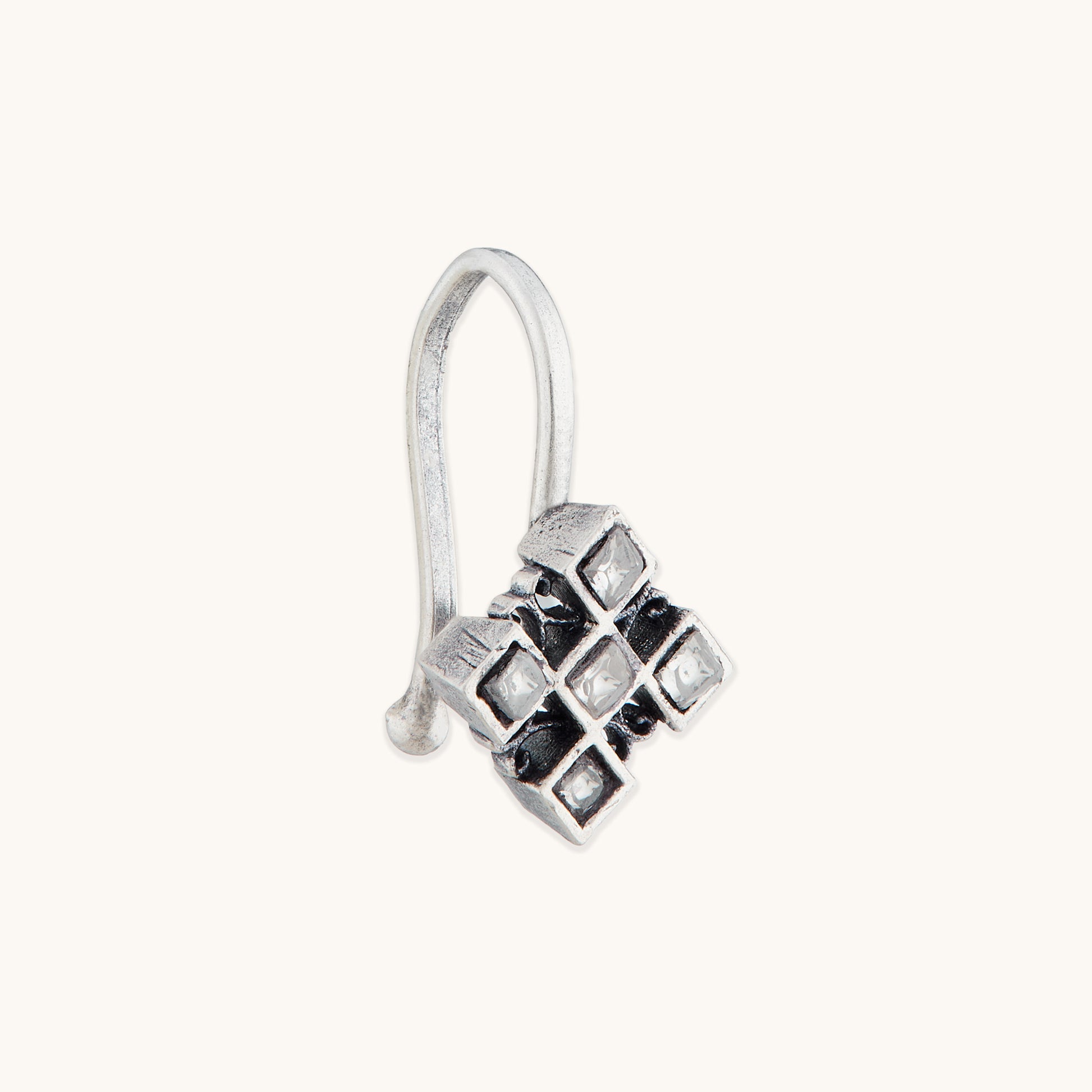 An angled view of a silver-toned, non-piercing nose ring showcasing a geometric, multi-square metal design with inset reflective stones.