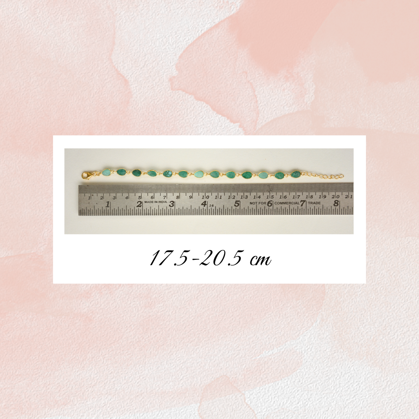 A green beryl gemstone chain bracelet placed alongside a metal ruler to demonstrate its adjustable length of 17.5 to 20.5 cm.