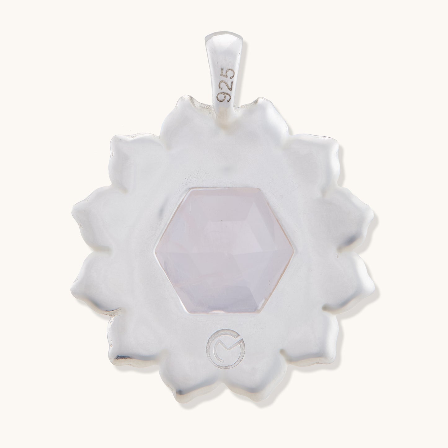 Back view of a refined gemstone pendant isolated on a white background, showcasing a polished finish and timeless, feminine design.