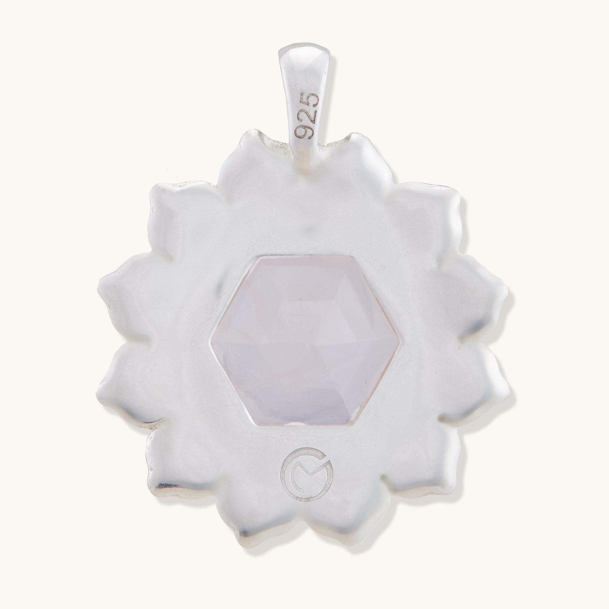 Back view of a refined gemstone pendant isolated on a white background, showcasing a polished finish and timeless, feminine design.