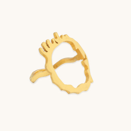 Side profile of a gold architectural ring highlighting the smooth inner band contrasted against the jagged, liquid-metal top surface.