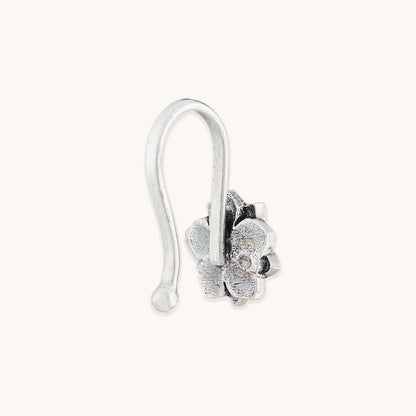 A side profile view of a silver-toned nose clip showing a 925 metal hallmark, featuring an ornate floral frame.