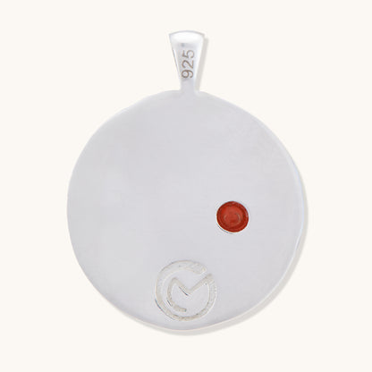 Back view of a sterling silver Full Moon pendant showing the 925 hallmark stamp and a single inlaid gemstone.