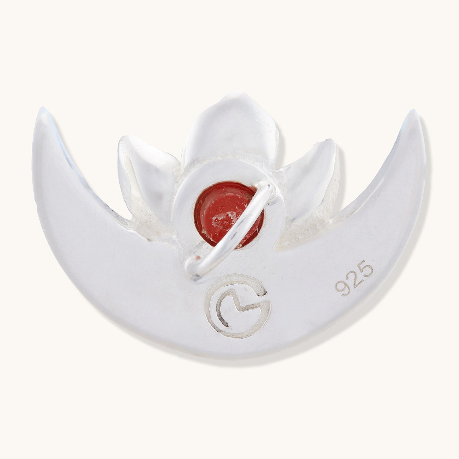 Back view of the sterling silver half-moon pendant, showing the "925" hallmark stamp and the reverse of the red gemstone setting.