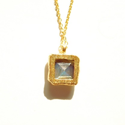 Back view of elegant sterling silver gemstone necklace piece featuring a natural, shimmering labradorite stone, highlighted against a clean studio backdrop.