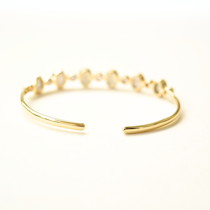 A refined sterling silver open cuff, highlighting the high-shine finish and unique gemstone detailing.