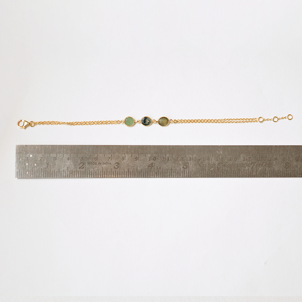 Bohemian-style layered bracelet with polished natural gemstones and an adjustable clasp.