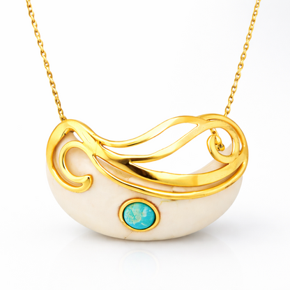 Close-up of the Mystic Turquoise Necklace featuring a crescent-shaped white stone base with a gold swirling overlay and a central turquoise gemstone.