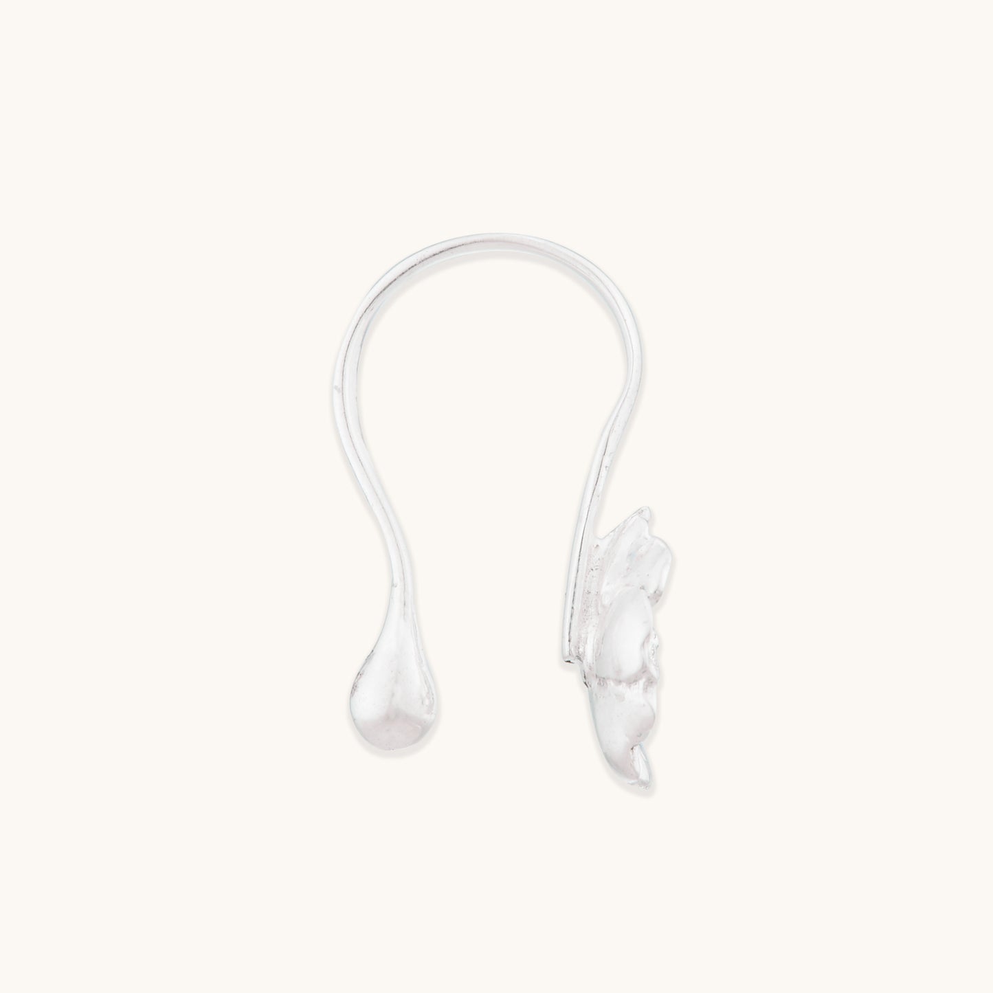 A clear, isolated view of a minimalist silver non-pierced nose ornament, highlighting the smooth curved arm and detailed bloom motif.