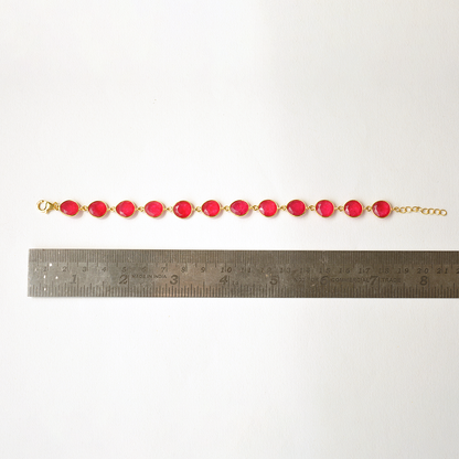 A minimalist silver chain bracelet with a blush-pink stone, displayed on a clean white background.