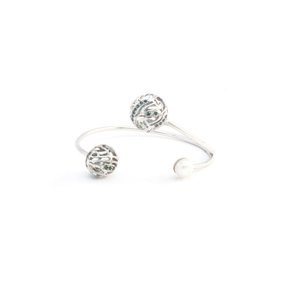 Front View of a silver open-design bracelet adorned with two intricate, hollow spherical charms and a pearl, isolated on a white background.