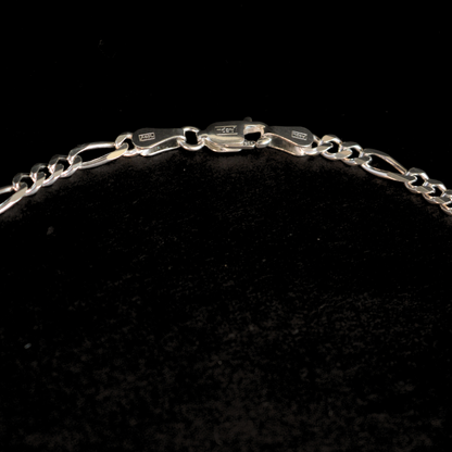 Studio shot of a contemporary circular silver necklace piece, emphasizing its clean lines and reflective finish.