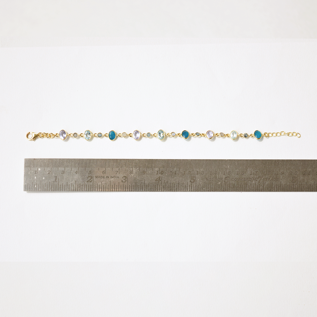An adjustable silver chain bracelet with vibrant gemstone charms, perfect for a sophisticated, everyday jewelry stack.