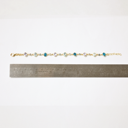 An adjustable silver chain bracelet with vibrant gemstone charms, perfect for a sophisticated, everyday jewelry stack.