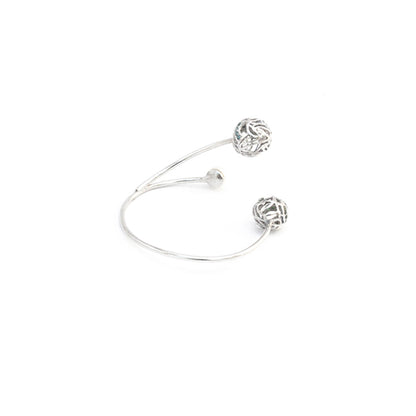 Side view of silver bracelet with white background.