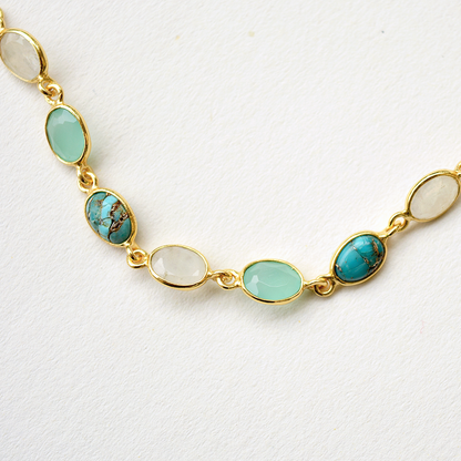A delicate multi-stone silver bracelet, emphasizing the rich blue hues and polished finish of the gemstones.